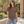 American Apparel 1301GD in Faded Brown, a stylish woman aged 30 at a modern architectural courtyard with caramel brick, greenery and natural sunlight; illustrative lifestyle mockup