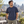 American Apparel 1301GD in Faded Navy, a stylish man aged 32 at an upscale Montreal rooftop terrace with a softly blurred urban skyline; illustrative lifestyle mockup