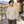 American Apparel 1304 in Sand, an East Asian man aged 30 at an elegant lakeside wooden deck with a modern chalet and bright autumn light; illustrative lifestyle mockup