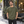 American Apparel 2001 in Olive, a stylish man aged 32 at a contemporary Montreal design district sidewalk outside a tasteful cafe; illustrative lifestyle mockup