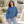 American Apparel RF496 in Sea Blue, a stylish woman aged 30 at a modern outdoor sculpture garden with light stone and softly blurred grasses; illustrative lifestyle mockup