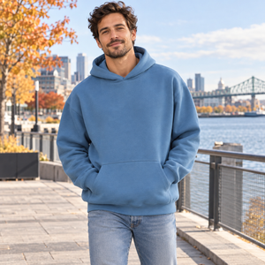 American Apparel RF498 in Sea Blue, a stylish man aged 30 at a modern Montreal waterfront promenade in soft bright autumn daylight; illustrative lifestyle mockup