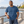 ATC ATC1000 Neptune Blue unisex cotton T-shirt — premium quiet waterfront promenade with pale concrete and distant water lifestyle photograph