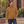 ATC ATCF2700 Caramel unisex quarter-zip sweatshirt — premium refined modern brick courtyard with warm stone steps lifestyle photograph