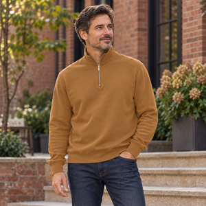 ATC ATCF2700 Caramel unisex quarter-zip sweatshirt — premium refined modern brick courtyard with warm stone steps lifestyle photograph