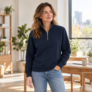 ATC ATCF2700 Dark Navy unisex quarter-zip sweatshirt — premium light filled creative workplace with oak furniture lifestyle photograph