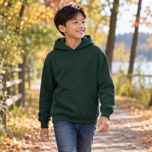 ATC ATCY2500 Dark Green youth pullover hoodie — premium tree lined family walking trail in soft autumn light lifestyle photograph