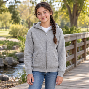 ATC ATCY2600 Athletic Heather youth full-zip hoodie — premium family park beside a simple timber footbridge lifestyle photograph