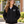 Adult Cedarcrest Elementary teacher in black CSW 24/7 L00555, white chest crest and horizontal STAFF on upper sleeve