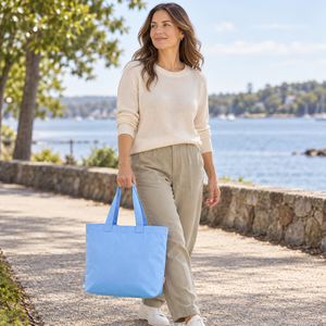 Woman carrying a Hydrangea Comfort Colors CCET0 Everyday Tote on a waterfront walk