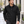 Model wearing the CORE365 88184 men's soft shell jacket on a city street - Black