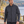 Model wearing the CORE365 88184 men's fleece bonded soft shell jacket beside a lake - Carbon