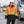 CX2 L01275 Kenworth 5-in-1 outer parka in Hi-Vis Orange, with detachable hood, snap storm flap and reflective bands — lifestyle view