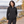 Model wearing the Adidas Women's Wind Resistant Full-Zip Jacket – A268 in a lifestyle setting - Black/ Black