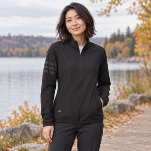 Model wearing the Adidas Women's Wind Resistant Full-Zip Jacket – A268 in a lifestyle setting - Black/ Black
