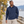 Model wearing the Adidas Men's Half-Zip Hooded Anorak – A607 in a lifestyle setting - Crew Navy