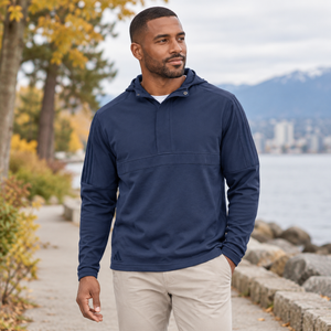 Model wearing the Adidas Men's Half-Zip Hooded Anorak – A607 in a lifestyle setting - Crew Navy