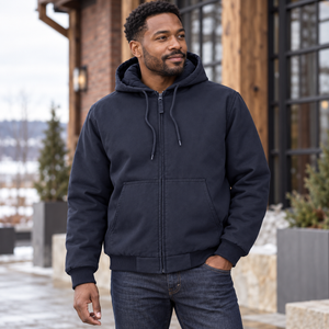 Model wearing the Harriton Unisex ClimaBloc® Heavyweight Hooded Full-Zip Jacket – M722 in a lifestyle setting - Dark Navy