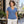 Woman wearing the M&O 3542 Heather Blue V-neck T-shirt at a Montreal cafe terrace