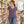 Woman wearing the M&O 3542 Heather Purple V-neck T-shirt in a modern bookstore