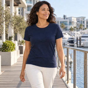 Woman wearing the M&O 4513 Fine Navy crewneck T-shirt on a marina boardwalk