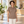 Woman wearing the Muskoka Trail S05751 Fairway Ladies Cotton/Poly Jersey Polo in a realistic lifestyle setting - Melange Taupe