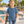 Next Level 3310 Youth Cotton Tee in Blue Jean — 12-year-old boy walking beside a colourful outdoor skate park, carrying a skateboard