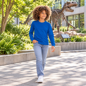 Next Level 3311 Youth Cotton Long Sleeve Tee in Royal — 12-year-old girl exploring a leafy science museum courtyard