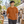 Next Level 3600 Unisex Cotton Tee in Clay — man browsing an outdoor design market in Montreal