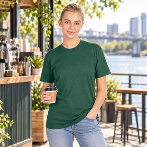 Next Level 3600 Unisex Cotton Tee in Royal Pine — woman at a bright riverside espresso kiosk