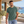 Next Level 3600SW Unisex Soft Washed Tee in Washed Royal Pine — man visiting a modern coastal architecture pavilion