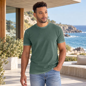 Next Level 3600SW Unisex Soft Washed Tee in Washed Royal Pine — man visiting a modern coastal architecture pavilion