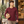 Next Level 3601 Unisex Cotton Long Sleeve Tee in Maroon — man picking up a sourdough loaf at a neighbourhood bakery