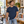 Next Level 3605 Unisex Cotton Pocket Tee in Midnight Navy — man in a design bookstore, standing beside an art-book display