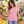 Next Level 3900 Women's Cotton Tee in Light Pink — woman selecting fresh fruit at a stylish open-air market