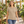 3910 Women's Cotton Relaxed Tee in Tan — woman walking through a botanical greenhouse with warm timber details
