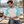 Next Level 6051 Unisex Triblend Three-Quarter Raglan Tee in Tahiti Blue Sleeves/ Heather White Body — man looking through film photographs at an outdoor picnic table