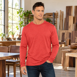 6071 Unisex Triblend Long Sleeve Tee in Vintage Red — man at a woodworking studio with finished furniture, no machinery in use