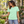 Next Level 6210 Unisex CVC Tee in Mint — woman choosing herbs at a courtyard plant shop