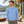 Next Level 6211 Unisex CVC Long Sleeve Tee in Heather Columbia Blue — man at an architect-designed lakeside cabin with a canoe in the background