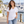 Next Level 6240 Unisex CVC V-Neck Tee in White — woman at a breezy marina boardwalk