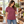 Next Level 6410 Unisex Sueded Tee in Heather Maroon — woman browsing handmade leather goods in a bright design shop
