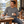 Next Level 6411 Unisex Sueded Long Sleeve Tee in Dark Heather Grey — man at an airy cabin table with a sketchbook and a coffee