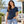 Next Level 6440 Unisex Sueded V-Neck Tee in Midnight Navy — woman on a landscaped waterfront terrace with modern architecture