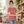 Next Level 6600 Women's CVC Relaxed Tee in Heather Mauve — woman arranging books in a minimal reading room