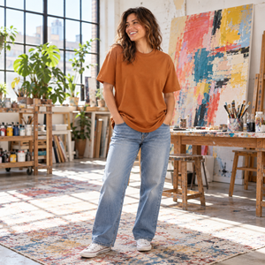 Next Level 7200 Unisex Heavyweight Tee in Clay — woman at an urban creative studio with a large colourful canvas