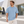 Next Level 7200 Unisex Heavyweight Tee in Stonewash Denim — man outside a minimalist contemporary design museum