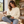 Next Level 9003 Unisex Santa Barbara Crewneck Sweatshirt in Natural — woman reading in a warm architectural reading nook