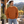 Next Level 9007 Unisex Heavyweight Crewneck Sweatshirt in Clay — man at a modern mountain lodge terrace in early autumn