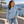 Next Level 9007 Unisex Heavyweight Crewneck Sweatshirt in Stonewash Denim — woman at a sculptural concrete lookout beside a lake
